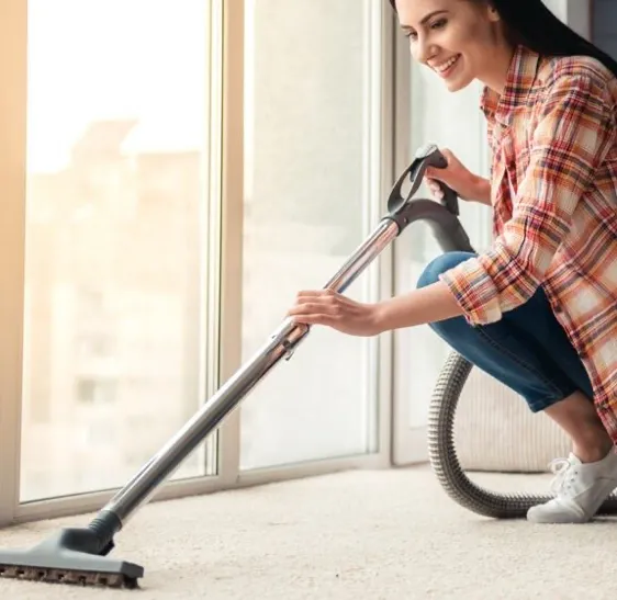 Happy lady cleaning carpet | Myers Carpet of Atlanta